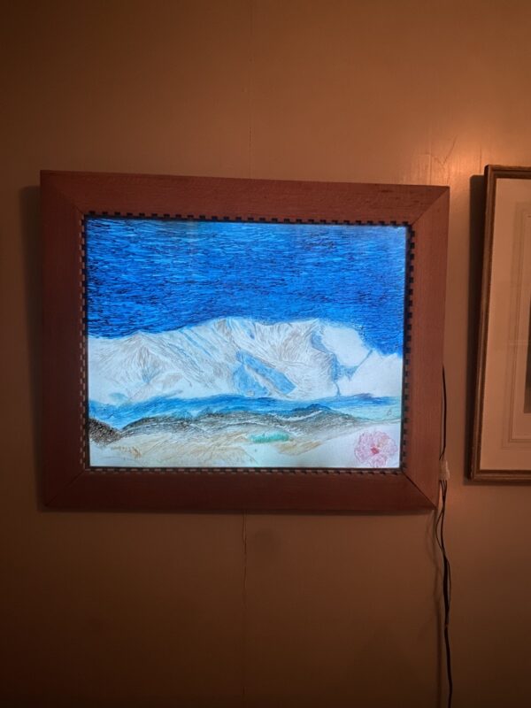 a framed painting of a sea on the wall